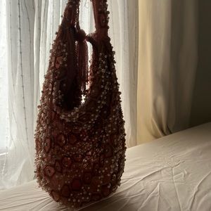 Signs of wear. beads have fallen off. Very pretty bag